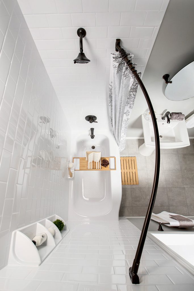 Top down view of a bathtub with a curved shower rod.
