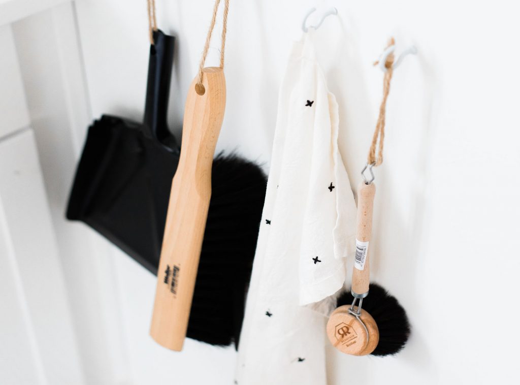 Brush and pail hanging from a wall hook